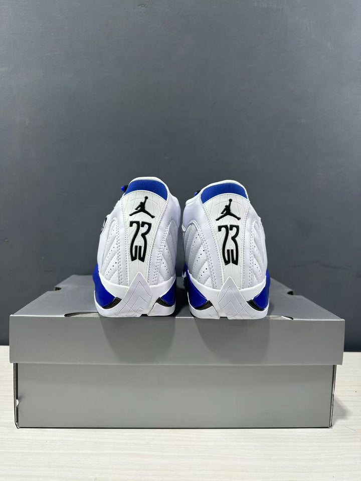 Rear view of the white and blue Jordan Air Jordan 14 sneakers placed on a gray shoe box.