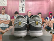 Rear view of silver and gray Nike basketball shoes with patterned uppers and gold-tone heel details