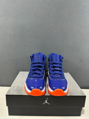 Front view of the pair showing blue tongues and laces, glossy blue toe areas, white midsoles, and orange toe traction.