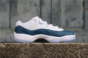 Side profile showing the navy patterned upper, white midsole, and low-top silhouette.