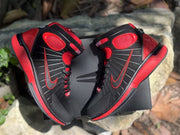 Overhead view of the pair showing the black uppers and contrasting red side accents.