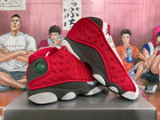 Angled view of the paired sneakers showing the red textured upper, circular side detail, and contrasting outsole.