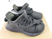 Close front three-quarter view showing the textured knit-style upper, matching laces, and ribbed outsole.
