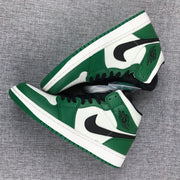 Top-down view of the pair, showing the black laces, green overlays, and white toe panels.