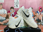 White Nike shoes shown from the side, with black Swoosh branding and textured detailing.