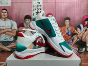 Angled view of the pair showing the graphic side panel, teal heel section, red outsole, and Nike branding.