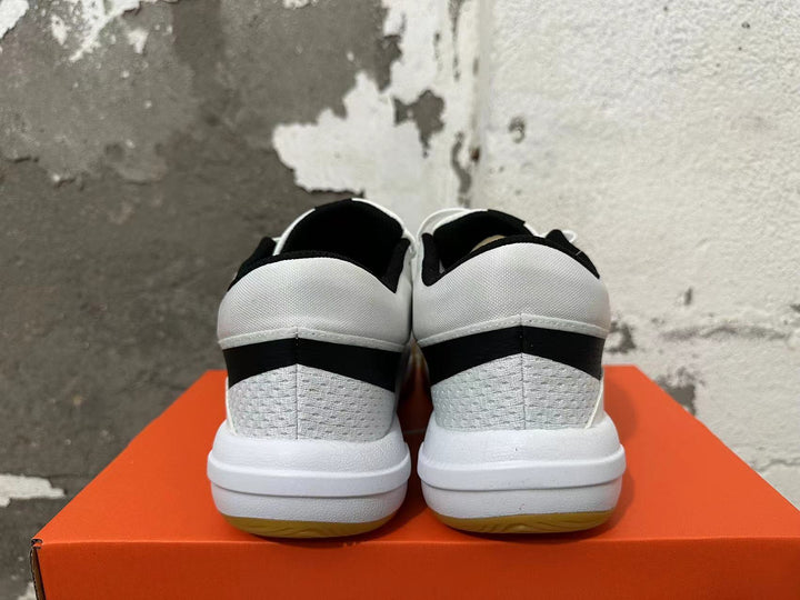 Rear view of white and black Nike Hyperquick low-top training shoes with gum-colored outsoles