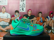 Side profile of one green-blue sneaker with a blue Swoosh, orange-blue splatter accents, and a translucent-looking outsole.