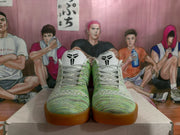 Front view of the pair showing the patterned green and white uppers, white laces, and Kobe tongue logos.