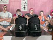 Rear view of the black Nike basketball shoes with embroidered heel details.