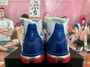 Rear view of the matching Nike high-top sneakers showing blue heel panels and red lower soles.