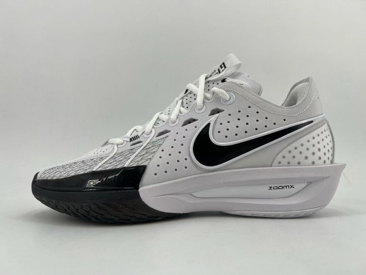 White and black Nike running shoe with perforated upper, black Swoosh, and ZoomX midsole marking