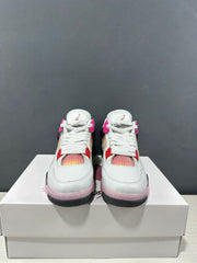 Front view of white, black, and pink Jordan Air Jordan 4 Retro sneakers displayed on a shoebox.