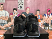 Rear view of black and dark purple Nike basketball sneakers on a black shoebox, with a basketball-themed illustrated backdrop.