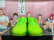 Front view of the matching green basketball sneakers with textured toe boxes, green laces, and red tongue details.