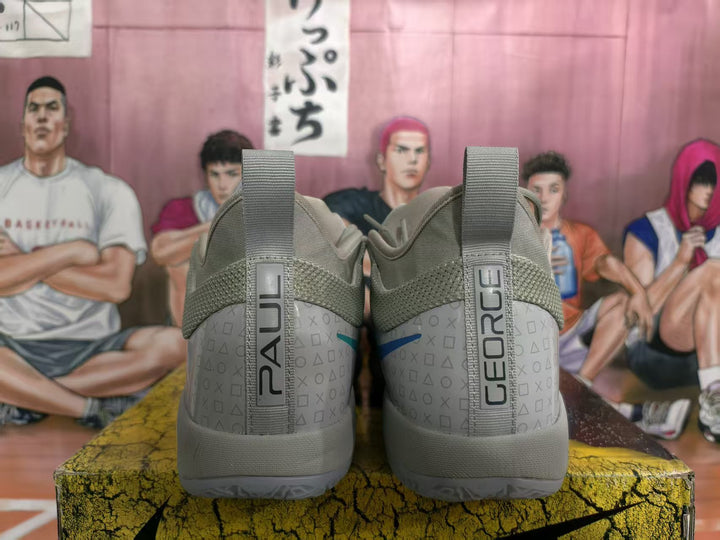 Rear view of gray Nike basketball sneakers showing pull tabs, patterned heel panels, and vertical NIKE branding.