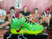 Side profile of a bright green sneaker with black laces, red-and-black swoosh branding, textured upper, and ZoomX text on the midsole.