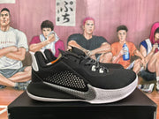 Side profile of a black basketball sneaker with a textured upper, gray side detail, white midsole, and Kobe branding.