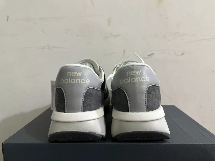 Rear view of black, gray, and white New Balance U370 sneakers