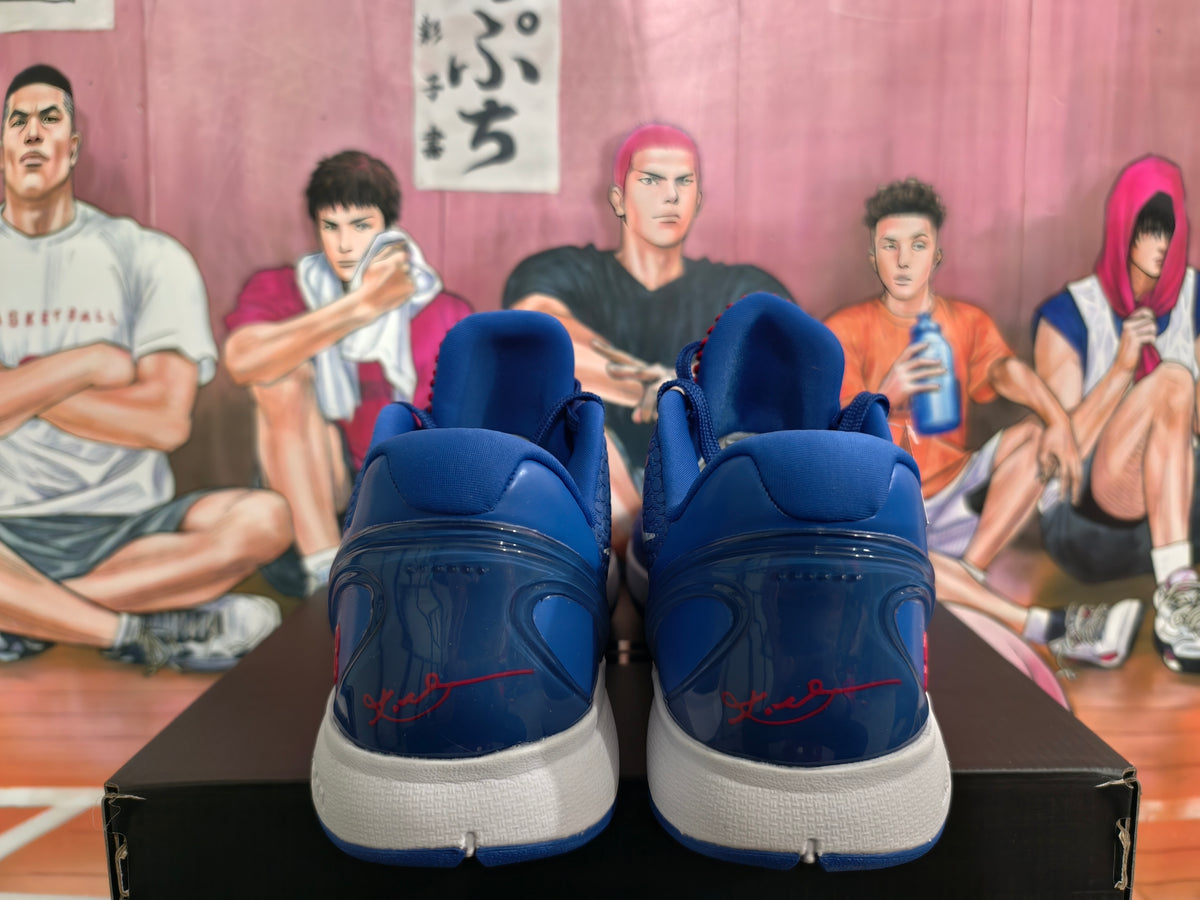 Rear view of blue Nike basketball sneakers showing padded collars, glossy heel panels, red detailing and white midsoles.