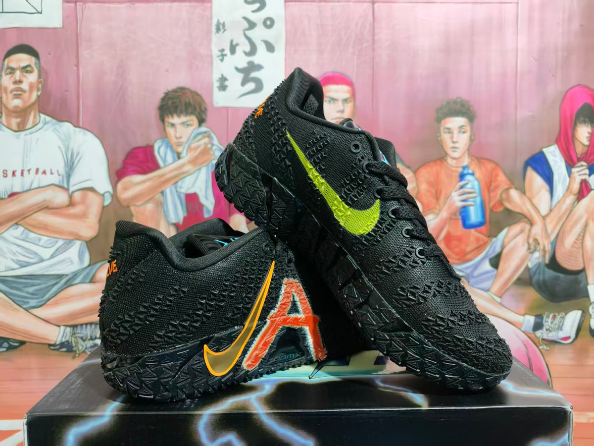 Pair of black Nike basketball shoes with textured uppers, orange and lime side graphics, and patterned outsoles.