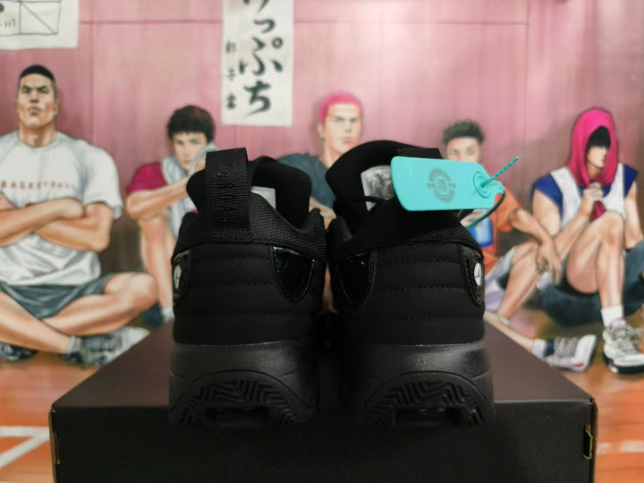 Rear view of black Jordan basketball shoes showing heel panels and outsoles.