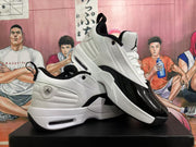 Angled product view showing both sneakers, their white and black color blocking, heel pull tabs, and visible sole cushioning windows.