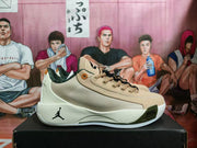 Side view of a beige Jordan basketball sneaker showing the mesh-textured panel, Jumpman midsole logo, and white outsole.