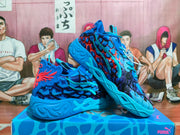 Angled view of blue basketball sneakers with coral accents and multicolor print