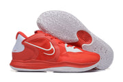 Red Nike Kyrie-style basketball shoe with white accents, shown beside its patterned outsole.