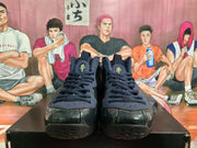 Front view of black and navy Nike basketball sneakers showing laces, perforated tongues and glossy toe panels.