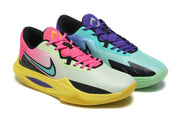 Two colorful basketball shoes in mismatched green, yellow, purple, and pink tones.