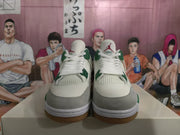 Front view of white and green sneakers showing white laces, gray toe overlays, mesh panels, and Jordan tongue logos.