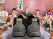 Rear view of black and grey Nike sneakers showing grey heel panels, black collars, and graphic heel details.