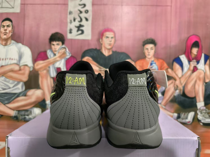 Rear view of black and grey Nike sneakers showing grey heel panels, black collars, and graphic heel details.