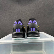 Rear view of black basketball sneakers showing purple heel accents and signature-style heel details.