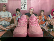 Front view of the pink sneaker pair showing the textured uppers, pink laces and black side swooshes.