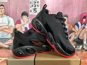 Angled view showing the black lace-up upper, red accents, and sculpted outsole of the sneakers.