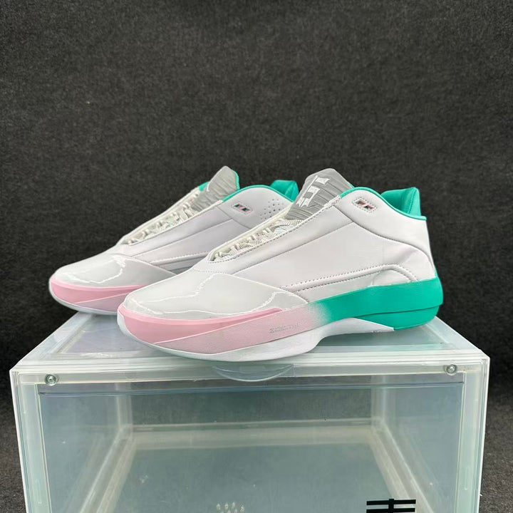 Pair of white low-cut basketball shoes with turquoise and pale pink accents, shown from the front and side.