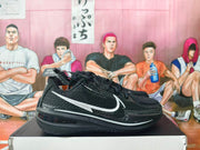 Side view of black Nike basketball shoes with a large silver Swoosh