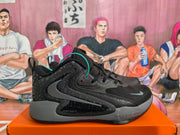 Side profile of a black and grey Nike basketball sneaker showing the patterned heel, layered side branding, grey midsole and black outsole.