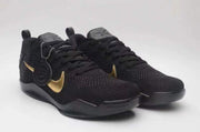 Pair of black and gold Nike Kobe 11 basketball shoes viewed from the front.