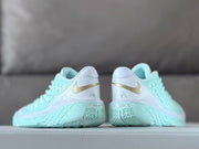 Rear view of the pair showing gold side logos and mint soles