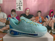 Side view of a pale aqua basketball shoe with blue midsole accents
