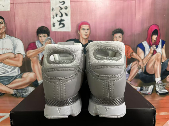 Rear view of grey and white Nike Kobe high-top basketball shoes
