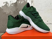 Angled view of a pair of green Nike shoes with white soles