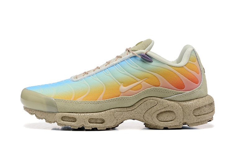 Side view of multicolor Nike Air Max Plus sneakers with a beige sculpted sole