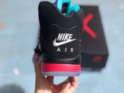 Heel view showing white Nike Air branding, a red midsole, and a translucent outsole edge.