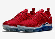 Pair of red sneakers in an angled front view with blue and clear soles.