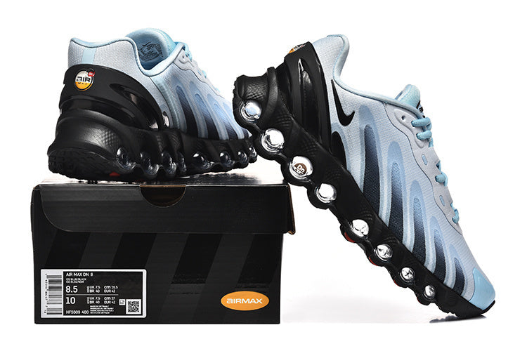 Light blue and black Nike Air Max DN sneakers displayed with a box showing a sample size label.